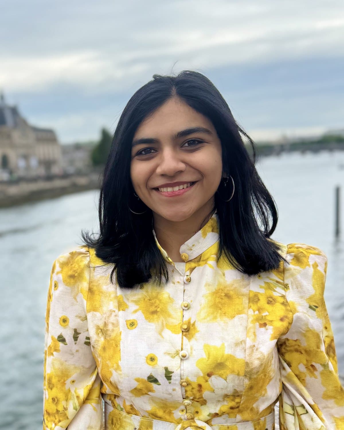 Devika, founder of Ferra, photographed outdoors beside a river.